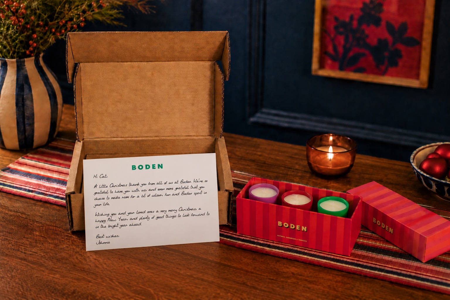 Boden Christmas gift box open on a table, with a personalised handwritten note inside