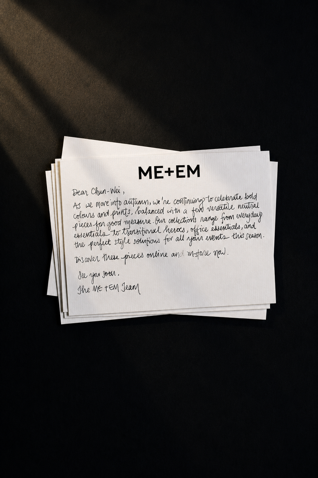 ME+EM handwritten note campaign — a stack of personalised notes on a dark background